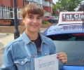 Alex with Driving test pass certificate